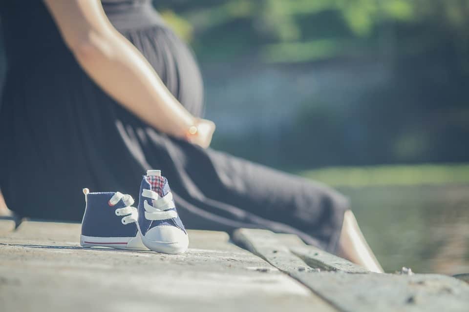 Pregnant lady sitting on wall