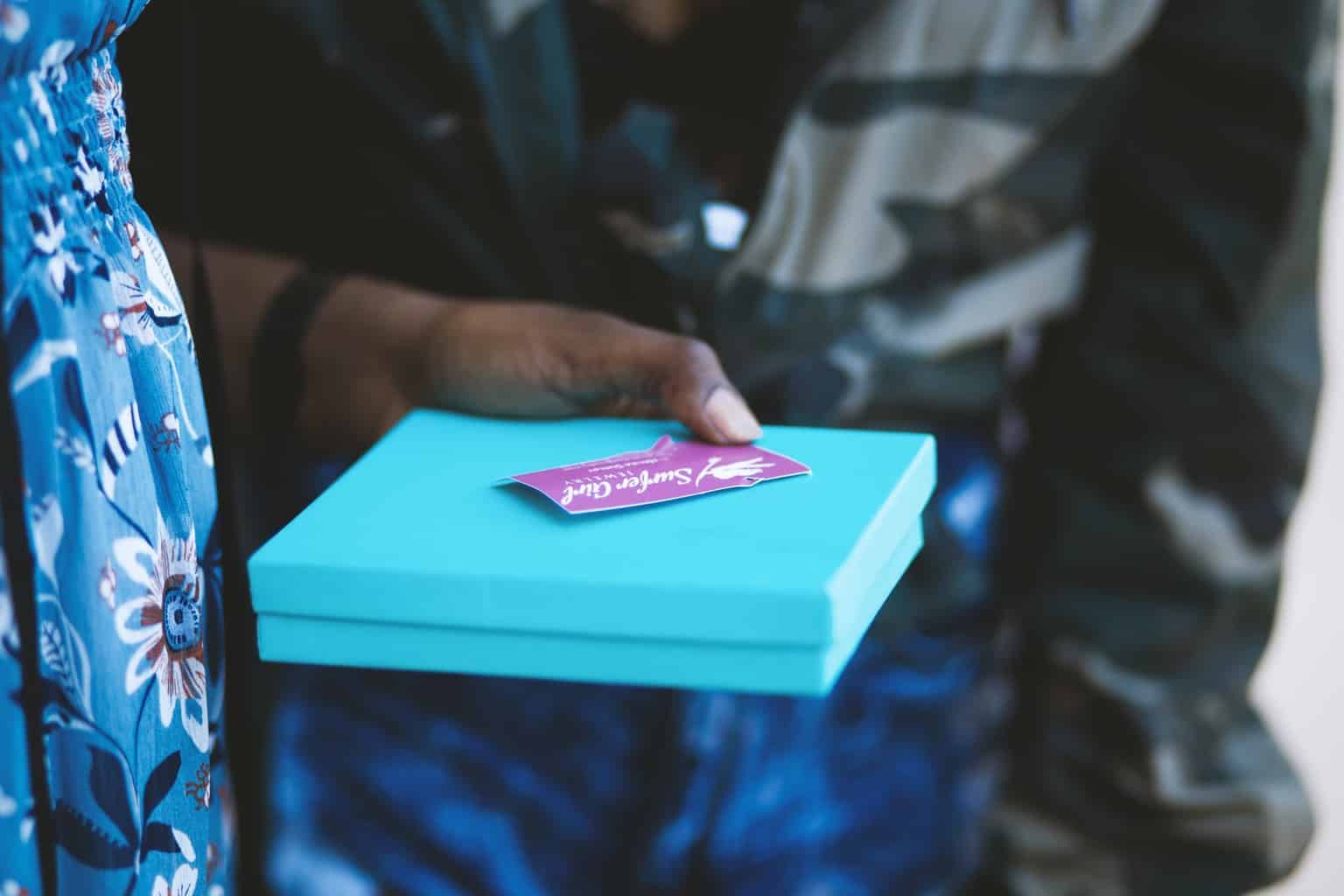 person holding blue box