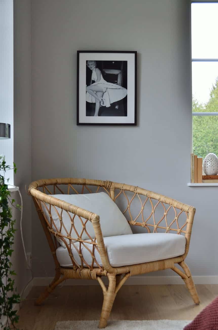 white wicker armchair near white wall