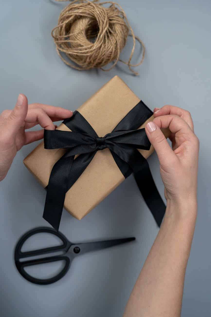 brown gift box with black ribbon