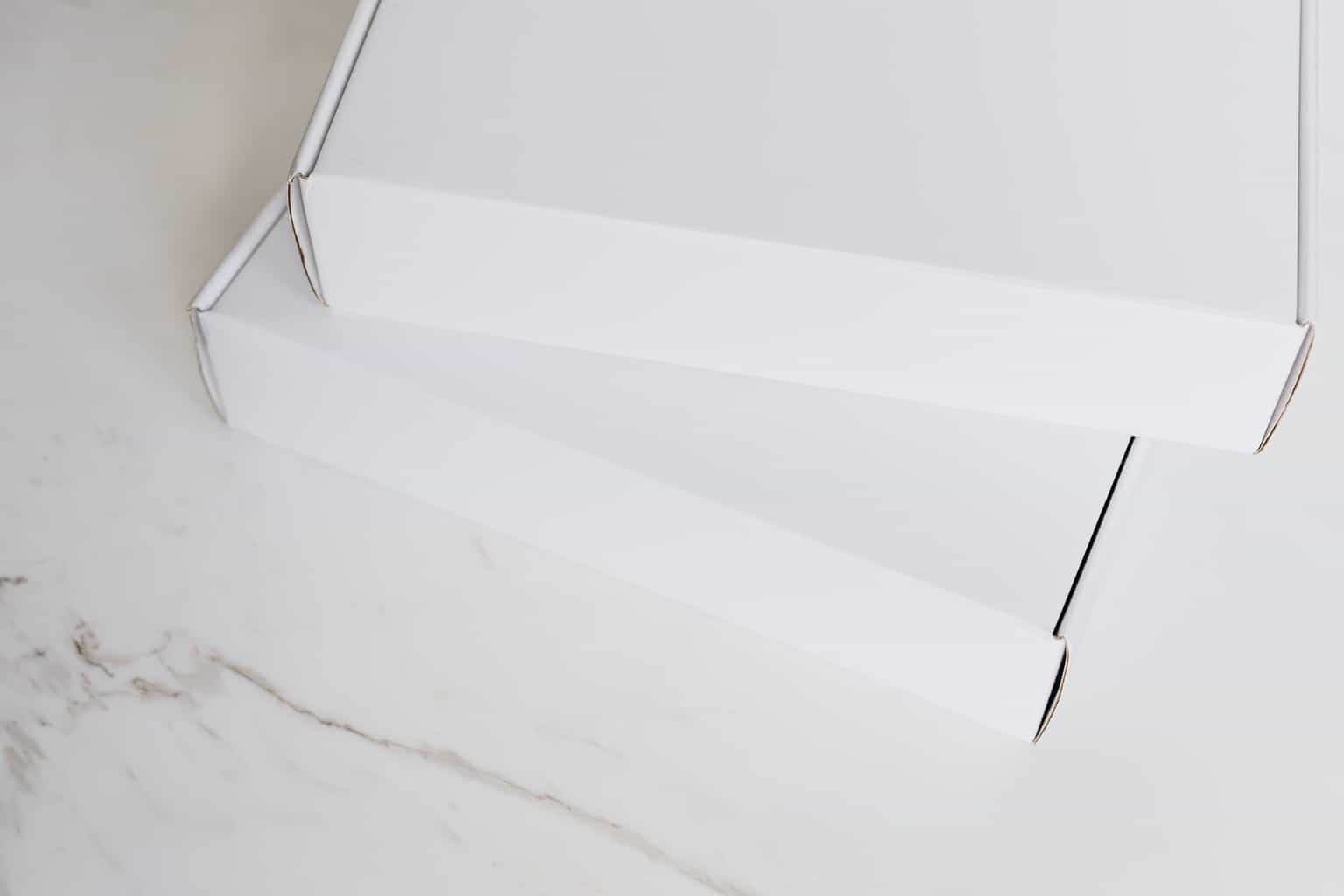 set of white carton packages on marble surface