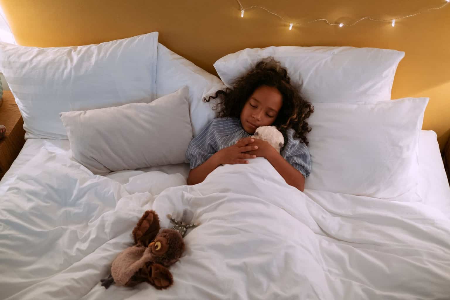 girl in white dress lying on bed