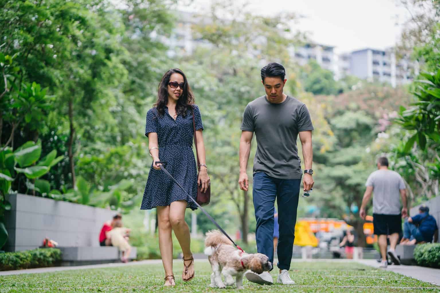 man in gray crew neck t shirt walking beside woman in black v neck dress