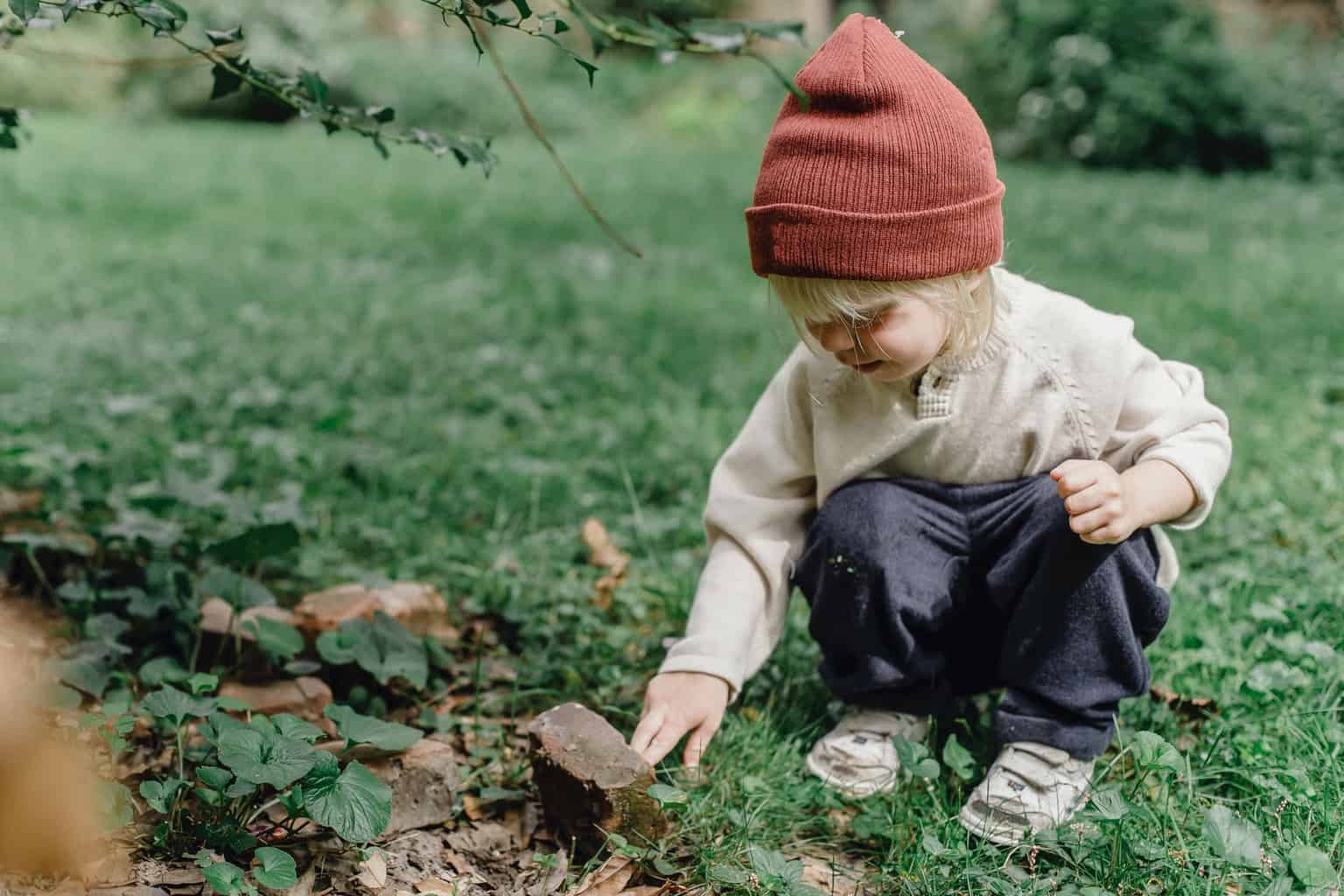 interested little boy exploring stone