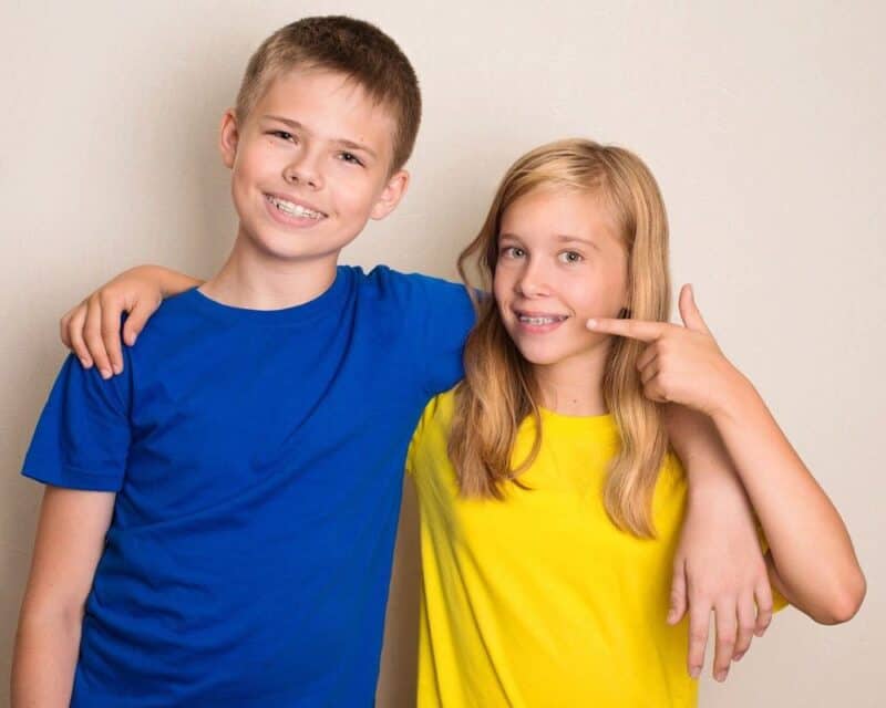 a boy and girl posing for a picture