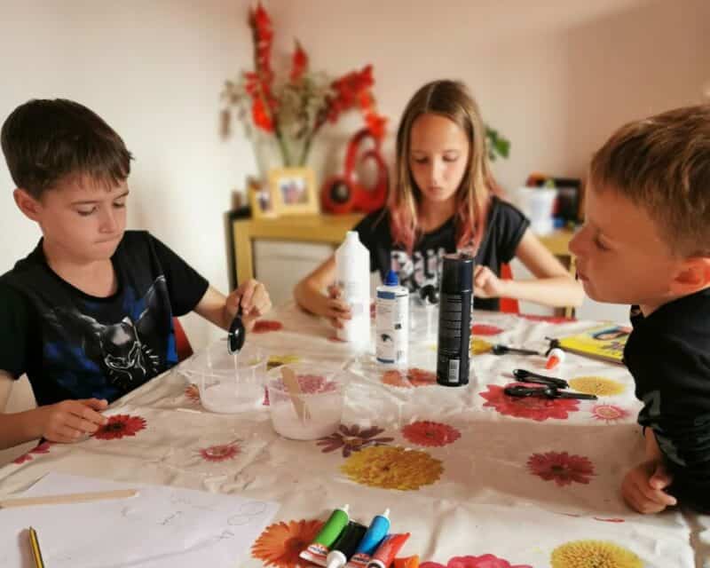 a group of kids sitting at a table