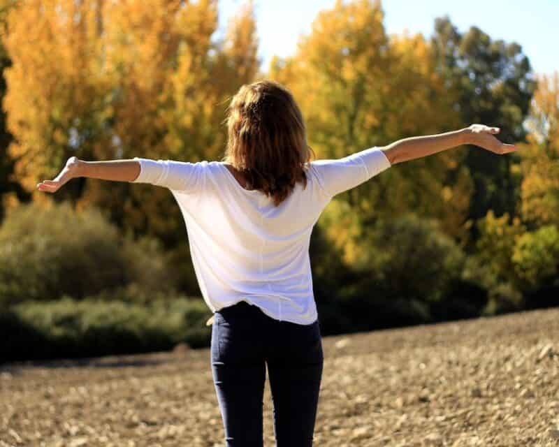 a woman with her arms out in the air