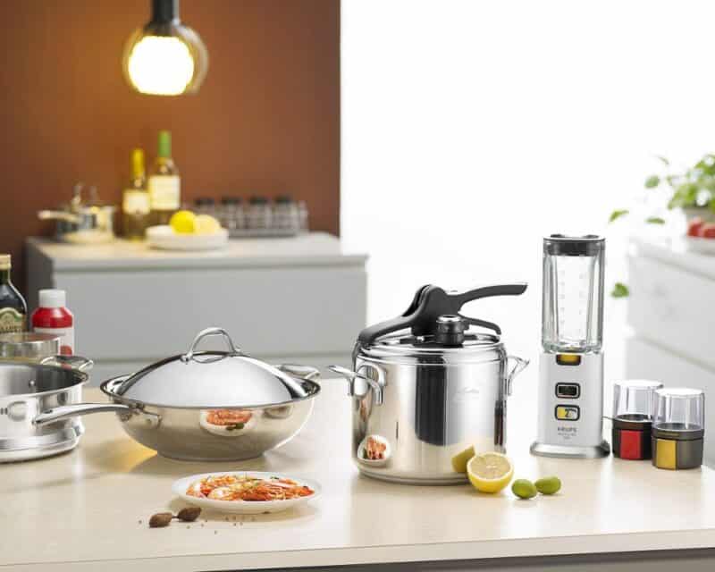 a kitchen counter with cooking utensils and a blender