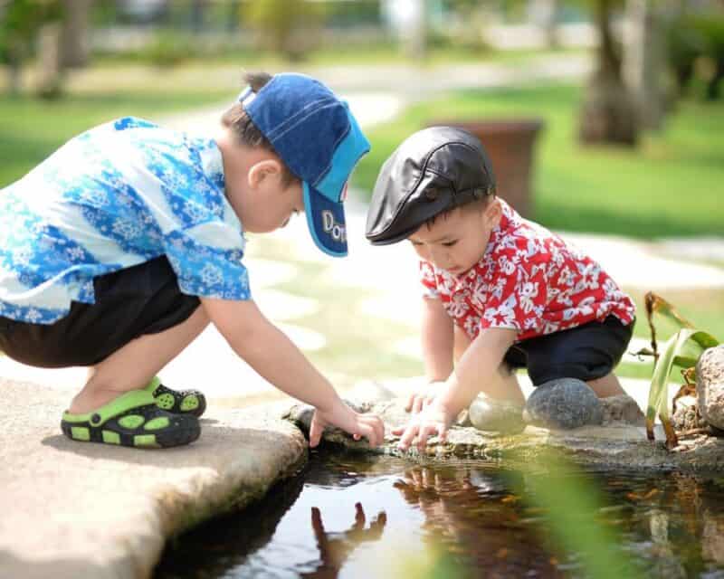 two boys playing with water