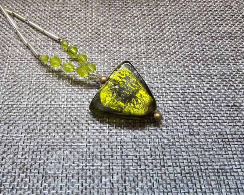 a necklace with a green and yellow pendant
