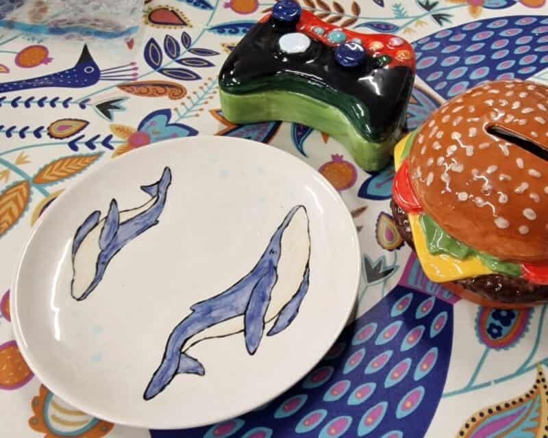 a plate and a plate with a painted burger and a game controller