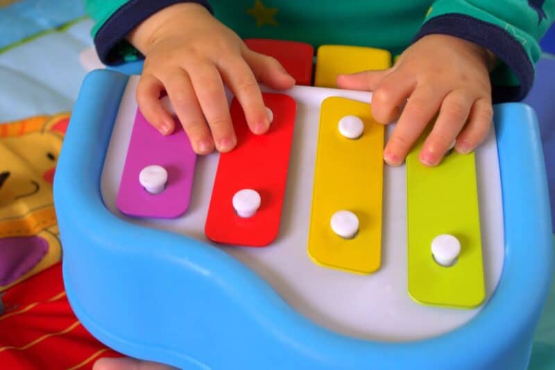 a child playing with a xylophone