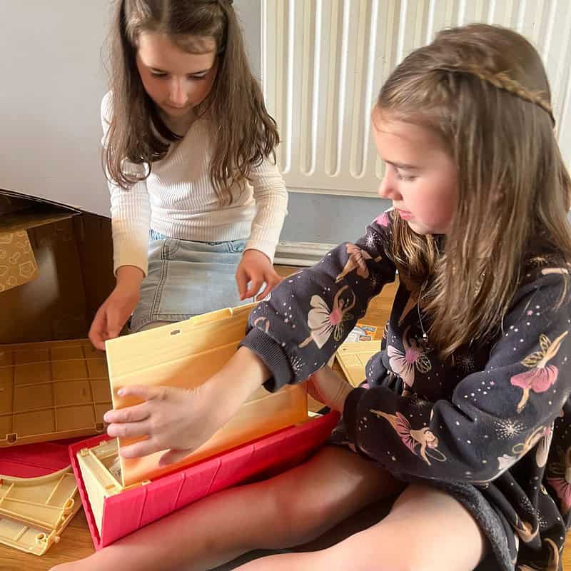 two girls sitting on the floor