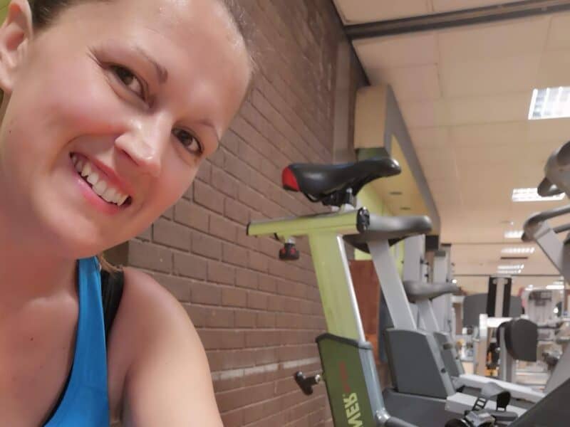 a woman smiling at camera at the gym