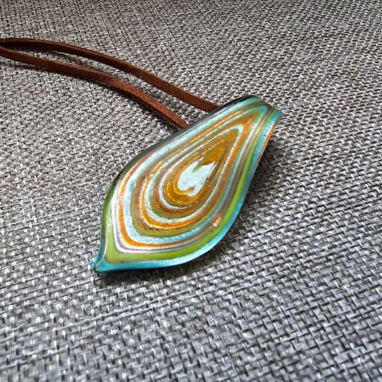 a colorful Murano glass necklace on a fabric surface