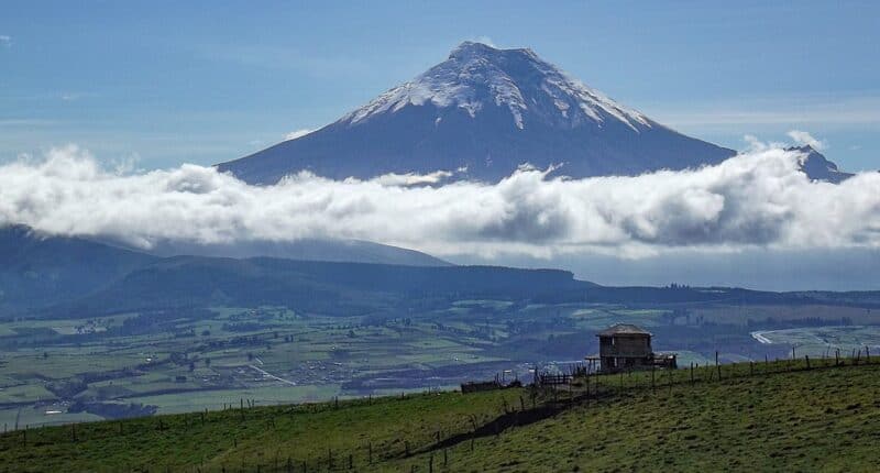 a mountain with clouds in the background