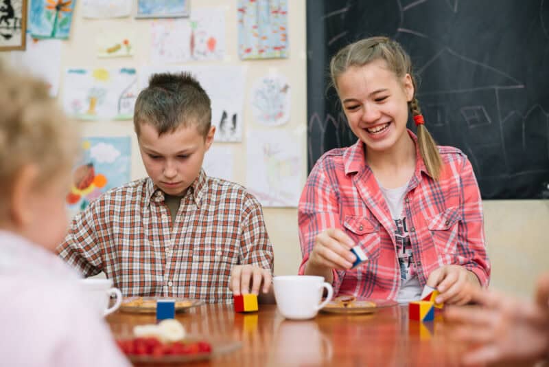 a group of children sitting at a table