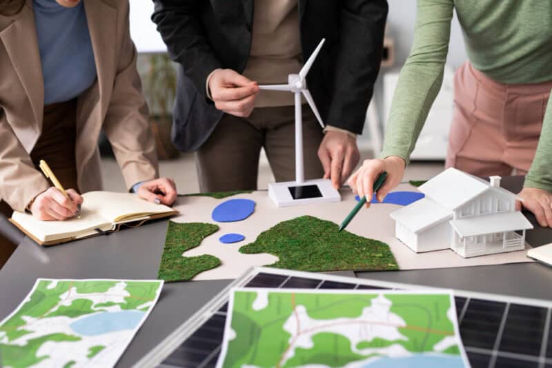 a group of people looking at a model of a windmill