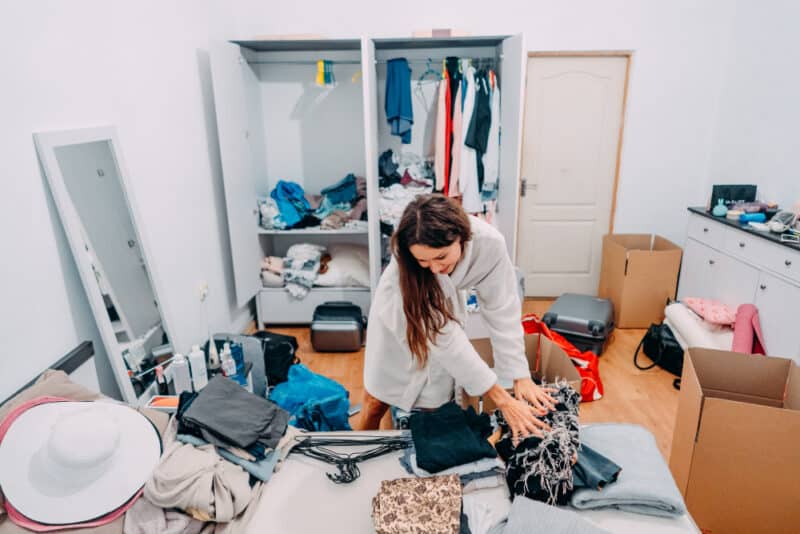 a woman folding clothes in a room