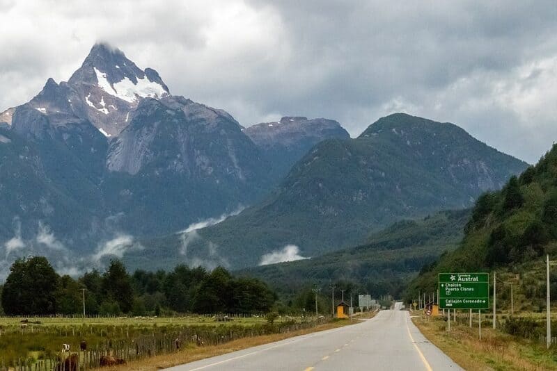 a road with mountains in the background